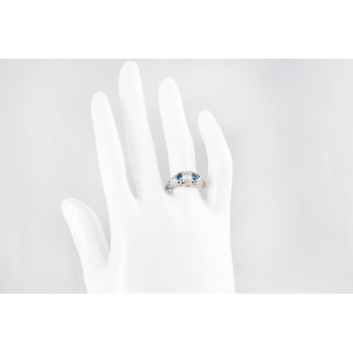 248 - AN AQUAMARINE AND DIAMOND DRESS RING, the emerald cut diamond flanked by trillion cut aquas, diamond... 