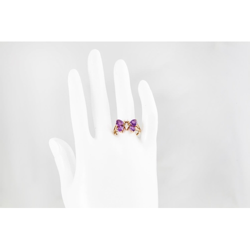 249 - AN AMETHYST AND DIAMOND NOVELTY RING, modelled as a butterfly, the amethyst wings to a diamond set b... 