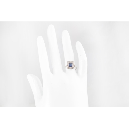 253 - AN EARLY 20TH CENTURY DIAMOND AND SAPPHIRE RING, the shield shaped sapphire to an old cut diamond su... 