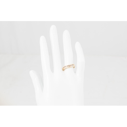 26 - A DIAMOND HALF ETERNITY RING, shaped form, the brilliant cut diamonds channel set in 14ct gold. Esti... 