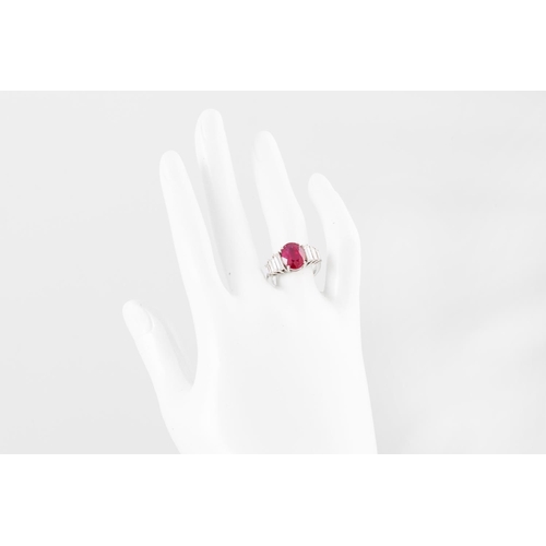 263 - A RUBY AND DIAMOND RING, the oval ruby to baguette diamond shoulders, mounted in gold. Estimated: we... 