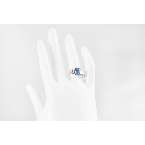 264 - A SAPPHIRE AND DIAMOND RING, the oval sapphire to baguette diamond shoulders, mounted in gold. Estim... 