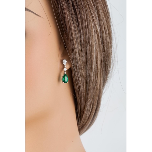 265 - A PAIR OF EMERALD AND DIAMOND DROP EARRINGS, the brilliant and pear shaped diamond lines suspending ... 