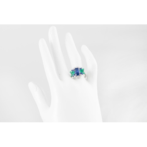 267 - A SAPPHIRE, EMERALD AND DIAMOND CLUSTER RING, the central octagonal sapphire to a marquise, pear and... 