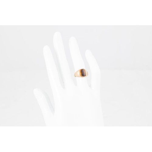 27 - A SIGNET RING, set with a Tiger's eye, mounted in 9ct gold, size I