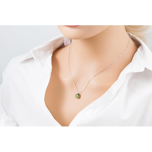 327 - A PERIDOT AND DIAMOND PENDANT, the oval peridot to diamond set bail, mounted in 18ct white gold, to ... 