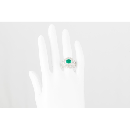 352 - AN EMERALD AND DIAMOND DRESS RING, the cabochon emerald to a tapered baguette surround, pavé diamond... 