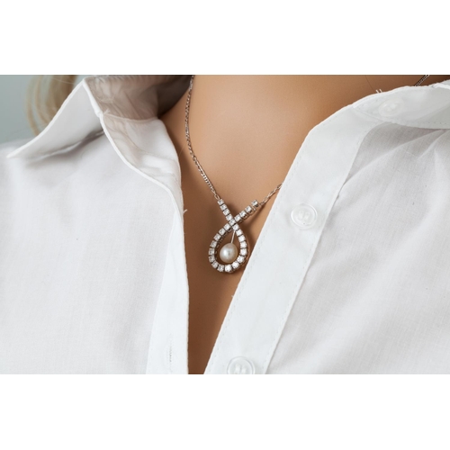 353 - A DIAMOND NECKLACE, comprising a shaped brilliant cut diamond pendant, suspending a pearl to the cen... 