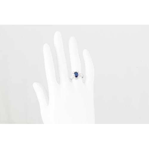 357 - A SAPPHIRE AND DIAMOND CLUSTER RING, the oval sapphire to a brilliant and baguette cut diamond surro... 