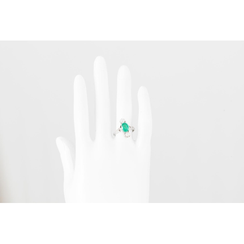 361 - AN EMERALD AND DIAMOND RING, the oval emerald flanked by two old cut diamonds, mounted in 18ct white... 