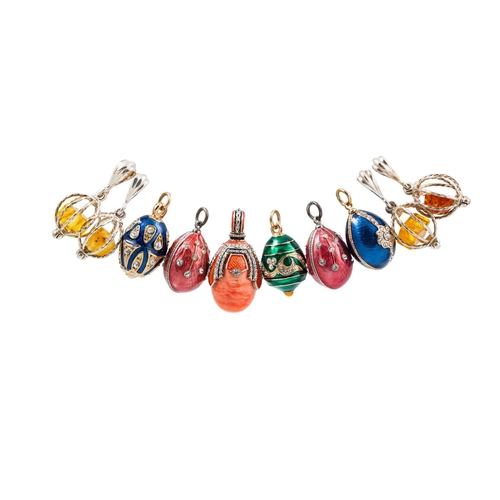 52 - A COLLECTION OF SEVEN EGG PENDANTS, enamelled decoration, together with four other pendants