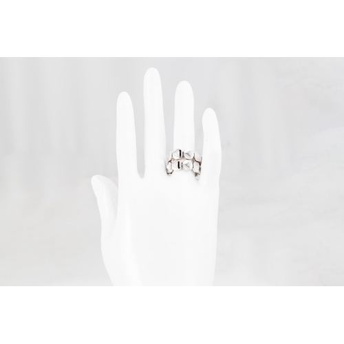 70 - AN 18CT WHITE GOLD RING, by Chimento, comprising shaped flexible links, size M - N