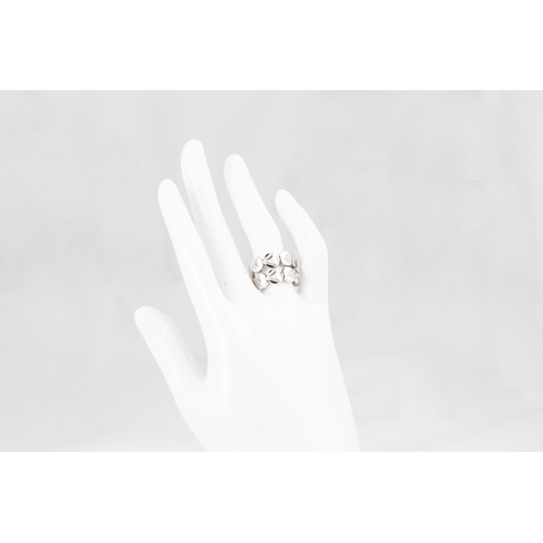 70 - AN 18CT WHITE GOLD RING, by Chimento, comprising shaped flexible links, size M - N