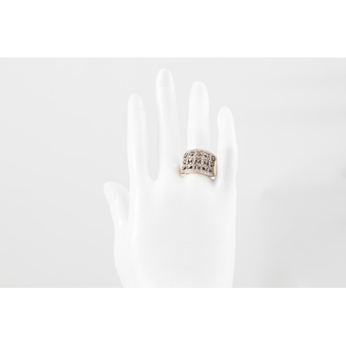 73 - A DIAMOND DRESS RING, comprising a panel set with alternate rows of champagne and white diamonds, mo... 