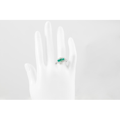 78 - A DIAMOND EMERALD CLUSTER RING, the three rectangular emeralds to a brilliant cut diamond surround, ... 