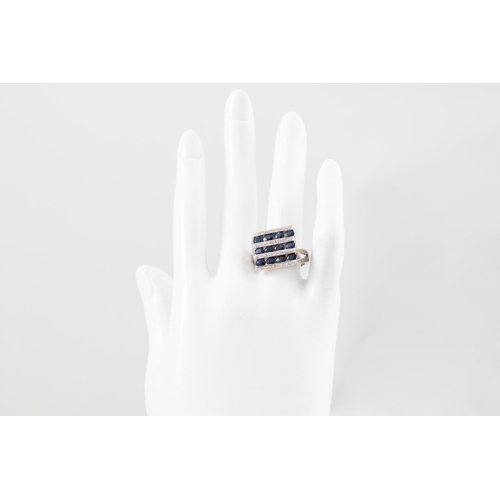 80 - A DIAMOND AND SAPPHIRE CLUSTER RING, of checker board form, the oval sapphires set between diamond l... 