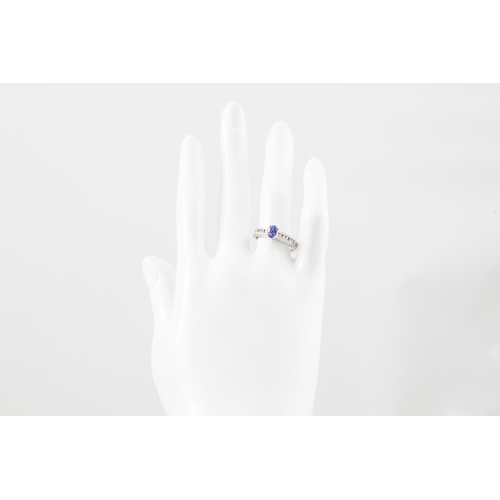 89 - A DIAMOND AND TANZANITE RING, the oval tanzanite to diamonds shoulders, mounted in 14ct white gold, ... 