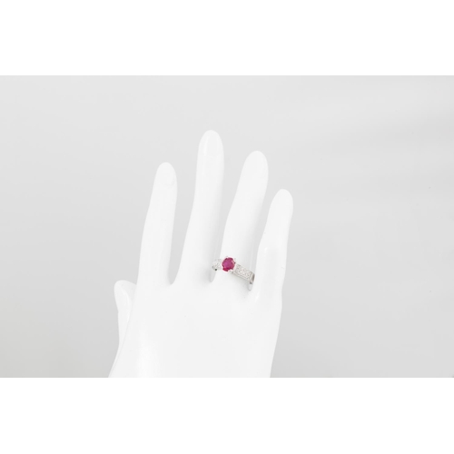 99 - A RUBY AND DIAMOND RING, the oval ruby to diamond set shoulders, mounted in 18ct gold. Estimated: we... 