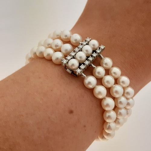 158 - A THREE ROWED PEARL BRACELET, the pearls measuring 7 mm to a brilliant cut diamond set clasp, mounte... 