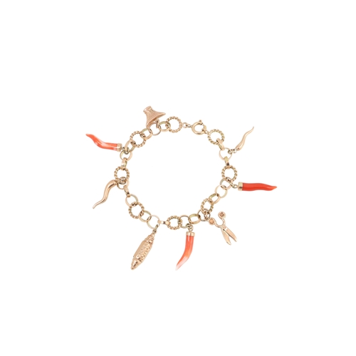 320 - A 14CT GOLD CHARM BRACELET, suspending various gold charms and coral charms