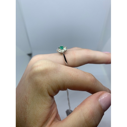 78 - A DIAMOND EMERALD CLUSTER RING, the three rectangular emeralds to a brilliant cut diamond surround, ... 