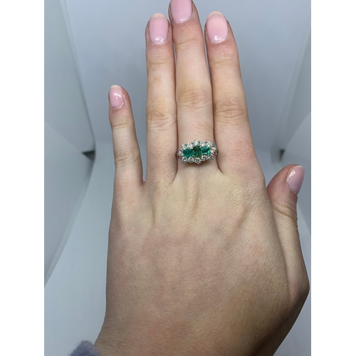 78 - A DIAMOND EMERALD CLUSTER RING, the three rectangular emeralds to a brilliant cut diamond surround, ... 