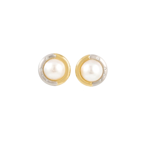 216 - A PAIR OF MOTHER OF PEARL EARRINGS, to a two tone gold and diamond surround