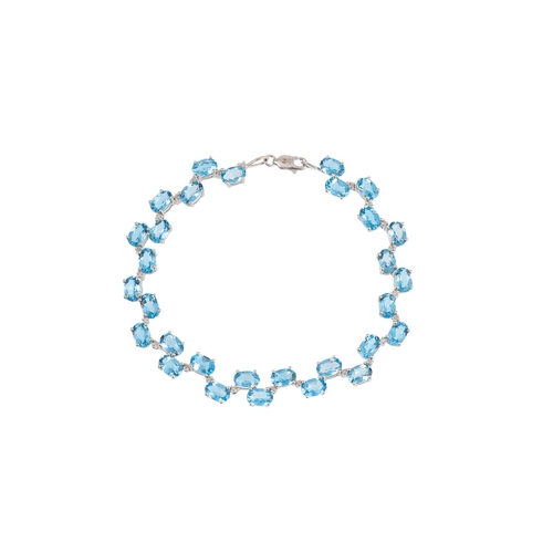 238 - A BLUE TOPAZ AND DIAMOND BRACELET, the oval topaz stone set between diamonds