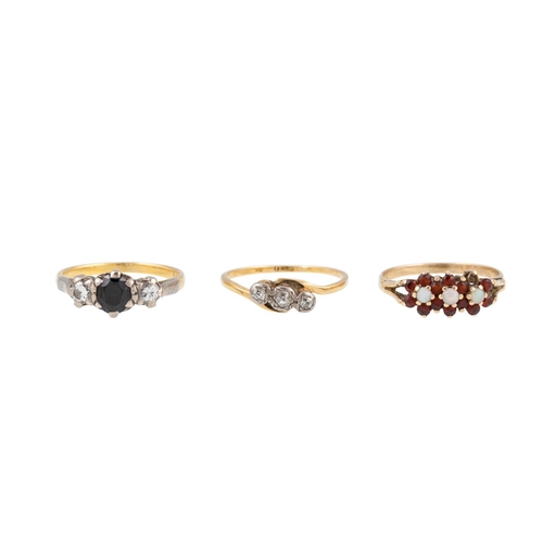 27 - THREE GEM SET RINGS, comprising a three stone diamond and sapphire ring, a three stone diamond ring ... 