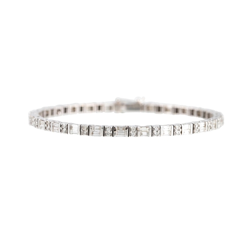 328 - A DIAMOND LINE BRACELET, set with brilliant cut diamonds and baguette cut diamonds, mounted in white... 