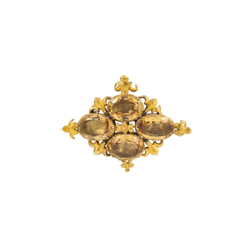 35 - A VICTORIAN TOPAZ BROOCH, of quatrefoil design, gold surround with Fleur de Lys motifs