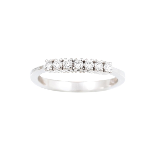 383 - A SEVEN STONE DIAMOND RING, the brilliant cut diamonds mounted in 18ct white gold. Estimated: weight... 