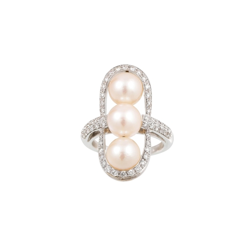 403 - A DIAMOND AND PEARL FINGER LINE RING, the three pearls set within a diamond surround, mounted in 18c... 