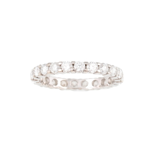 446 - A DIAMOND ETERNITY RING, the brilliant cut diamonds mounted in white gold. Estimated: weight of diam... 