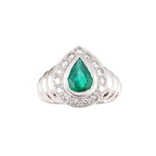 447 - AN EMERALD AND DIAMOND CLUSTER RING, the pear shaped to a brilliant cut diamond surround, to an 18ct... 