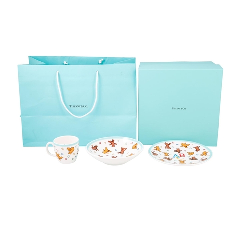 513 - A BOXED MODERN CERAMIC TIFFANY & CO. THREE PIECE CHRISTENING SET, comprising of alphabet bear patter... 