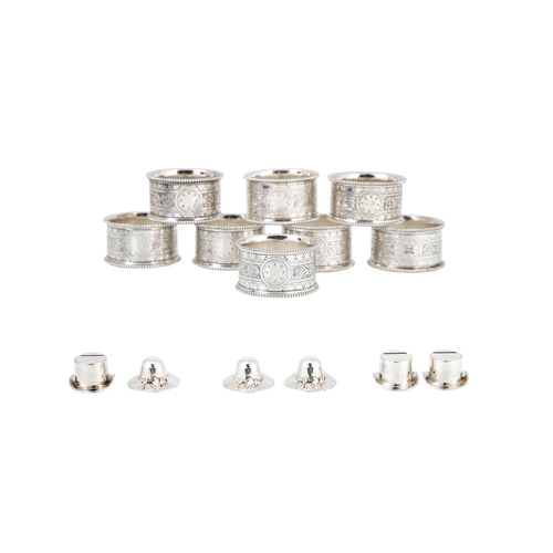 536 - A CASED SET OF EIGHT SILVER PLATED NAPKIN RINGS, together with a cased set of six silver plated menu... 