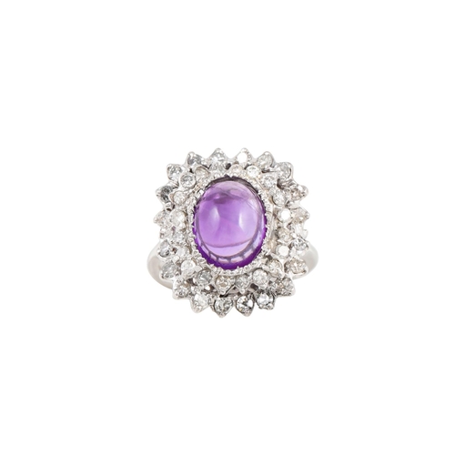 87 - AN AMETHYST AND DIAMOND CLUSTER RING, the cabochon amethyst to a two tiered diamond surround.  Estim... 