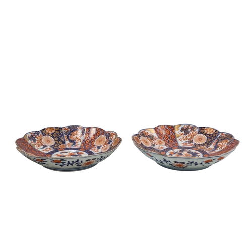 570 - A PAIR OF LATE 19TH CENTURY JAPANESE IMARI OPEN BOWLS, of wavy form, hand painted decorative panels.... 