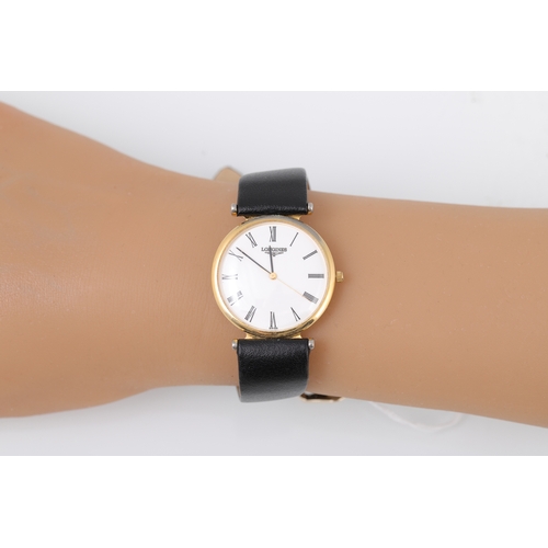 197 - A LADY'S LONGINES GOLD PLATED WRIST WATCH, white face with Roman numerals, black strap