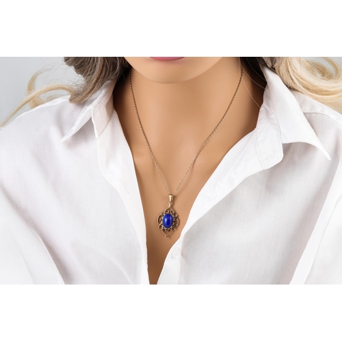 10 - A LAPIS LAZULI PENDANT, on a gold chain