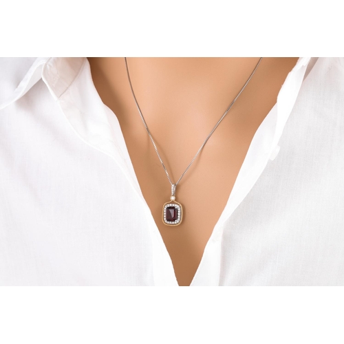 134 - A GARNET AND DIAMOND CLUSTER PENDANT, the rectangular garnet to diamond surround and bail, mounted i... 