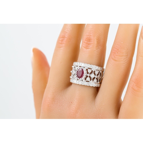 171 - A DIAMOND AND RUBY RING, the oval ruby to an open worked diamond set band, mounted in white metal.  ... 