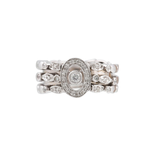 176 - A DIAMOND CLUSTER RING, the central cluster to a three rowed diamond shoulders, mounted set in white... 