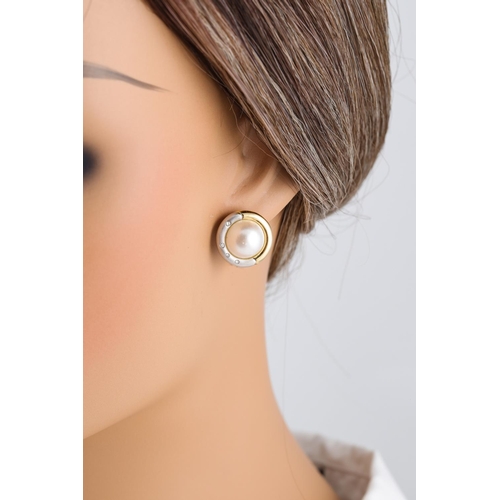 216 - A PAIR OF MOTHER OF PEARL EARRINGS, to a two tone gold and diamond surround