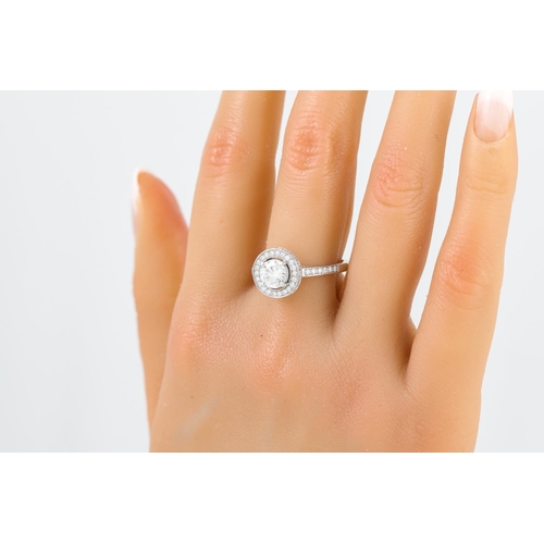 249 - A DIAMOND TARGET RING, the brilliant cut diamond to a brilliant cut diamond surround and shoulders, ... 