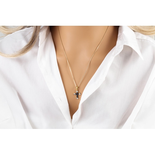 258 - A DIAMOND AND SAPPHIRE CROSS, mounted in gold, on a gold chain