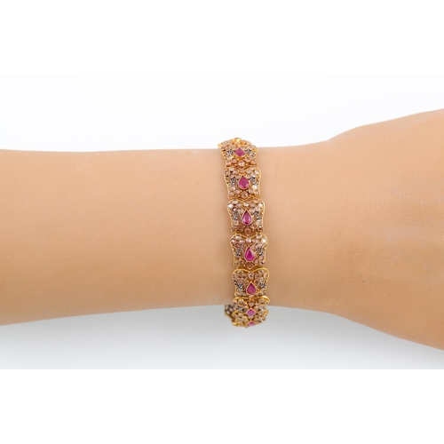 264 - A RUBY AND ROSE CUT DIAMOND BRACELET, each shaped 18ct gold link set with a pear shaped ruby and dia... 