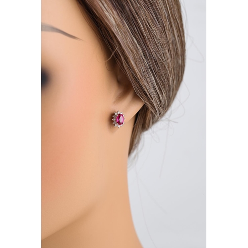 265 - A PAIR OF DIAMOND AND PINK SAPPHIRE EARRINGS, of oval form, mounted in white  gold. Estimated: weigh... 