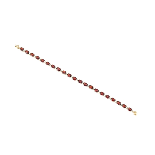 276 - A GARNET SET BRACELET, the oval stones, mounted in 14ct yellow gold